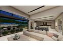 Open-concept living room and kitchen boast natural light with seamless flow to an outdoor area at 7349 Olive Creek Ct, Las Vegas, NV 89117