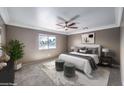 Cozy bedroom with soft natural light, neutral tones, ceiling fan, and comfortable carpeted floors at 861 S Ford Loop, Pahrump, NV 89048