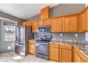 Well-equipped kitchen with stainless steel appliances, plentiful wood cabinetry, and durable countertops at 861 S Ford Loop, Pahrump, NV 89048