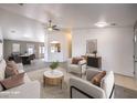 Bright, modern living room with stylish furniture, ceiling fan, and an open floor plan at 861 S Ford Loop, Pahrump, NV 89048