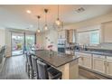 Modern kitchen featuring an island with seating, stainless steel appliances, and stylish pendant lighting at 10031 Fletcher Peak Ave, Las Vegas, NV 89178