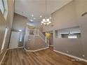 Bright living room with hardwood floors, high ceilings and a modern chandelier at 10279 Montes Vascos Dr, Las Vegas, NV 89178