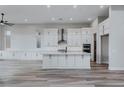 This spacious kitchen features an island, a suite of stainless steel appliances, and custom cabinetry at 11173 Concord Valley Dr, Las Vegas, NV 89135