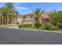 Attractive two-story home featuring desert landscaping, terracotta roof, and a three-car garage at 1312 Fragrant Spruce Ave, Las Vegas, NV 89123