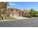 Beautiful two-story home with three-car garage, desert landscaping, and terracotta roofing at 1312 Fragrant Spruce Ave, Las Vegas, NV 89123