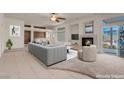 Open-concept living room showcasing a fireplace, bar, and access to a pool through sliding glass doors at 1312 Fragrant Spruce Ave, Las Vegas, NV 89123