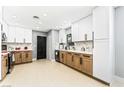 Modern kitchen featuring a combination of white and wood cabinets and light wood-look flooring at 1415 Helen Ave, North Las Vegas, NV 89030