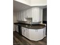 Traditional-style kitchen features white cabinets and dark countertops at 1502 Cliff Branch Dr, Henderson, NV 89014