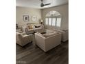 Bright living room with hardwood floors, neutral paint, ceiling fan and lots of natural light at 1502 Cliff Branch Dr, Henderson, NV 89014