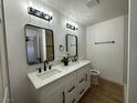 Bright bathroom with dual vanity, contemporary mirrors, modern lighting, and a sleek, minimalist design at 1600 E Mcdonald Ave, North Las Vegas, NV 89030