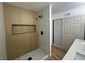 This bathroom offers a tiled shower with built-in niche and a modern vanity at 1600 E Mcdonald Ave, North Las Vegas, NV 89030