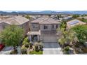 Charming two-story home with desert landscaping, mature trees, and a two-car garage at 2449 Daks Loden Ct, Henderson, NV 89044