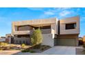 Contemporary two-story home with a two-car garage and modern architectural style at 25 Canyon Bay Dr, Henderson, NV 89011