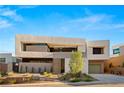 A modern designed two-story home featuring clean lines and a well-manicured desert landscape at 25 Canyon Bay Dr, Henderson, NV 89011