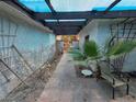 Enclosed courtyard with brick pavers and chairs with wood pergola creating a peaceful outdoor area at 2544 Malabar Ave, Las Vegas, NV 89121