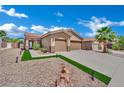 Inviting home with a stucco exterior, landscaped yard, and a driveway leading to a two-car garage at 2558 Wiltshire Ave, Henderson, NV 89052