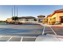 View of clubhouse with desert landscaping, circle drive and covered entry at 3124 Kookaburra Way, North Las Vegas, NV 89084