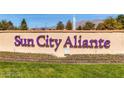 The Sun City Aliante sign with fresh green grass and a fountain with mountains in the background at 3124 Kookaburra Way, North Las Vegas, NV 89084