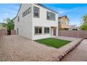 A modern backyard with gravel, artificial grass, and a low brick wall at 3712 Gilmore Creek St, Las Vegas, NV 89129