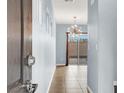 Inviting foyer with tile flooring and a modern light fixture leads to the outdoor patio at 3712 Gilmore Creek St, Las Vegas, NV 89129
