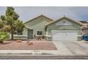 Charming single-story home featuring desert landscaping, attached garage, and neutral toned stucco exterior at 4318 Scarlet Vista Ct, North Las Vegas, NV 89031