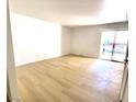 Bright living room with sliding doors to a balcony and modern light wood floors at 4421 Alexis Dr # 429, Las Vegas, NV 89103