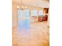 Charming dining room with travertine floors seamlessly flows into kitchen at 4726 Castle Rock Ct, Las Vegas, NV 89147