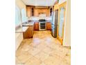 Well-equipped kitchen with granite countertops, stainless appliances, and travertine floors at 4726 Castle Rock Ct, Las Vegas, NV 89147