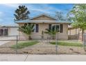 A cozy home featuring desert landscaping and a small outdoor seating area at 4739 Glenndavis Dr, Las Vegas, NV 89121