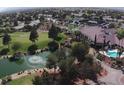 Aerial view of a community clubhouse, pool, and golf course at 4833 Lawnwood Ct, Las Vegas, NV 89130