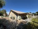 Fenced backyard with a covered patio and low-maintenance desert landscaping at 4833 Lawnwood Ct, Las Vegas, NV 89130
