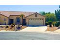 Charming single-story home with desert landscaping and two-car garage at 4833 Lawnwood Ct, Las Vegas, NV 89130