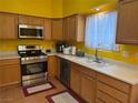 Bright kitchen featuring stainless steel appliances, ample counter space and plenty of cabinets at 4833 Lawnwood Ct, Las Vegas, NV 89130