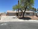 Charming single-story home featuring a brick accent and two-car garage at 5030 Salinaz Cir, Las Vegas, NV 89118