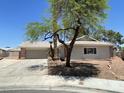 Charming single-story home featuring a brick accent and two-car garage at 5030 Salinaz Cir, Las Vegas, NV 89118