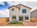 A cozy backyard with an outdoor seating area, small artificial turf, and low maintenance landscape at 551 Ruby Robin Ave # Lot 750, Henderson, NV 89011