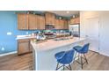 Well-lit kitchen features quartz countertops, an island with seating, and stainless steel appliances at 551 Ruby Robin Ave # Lot 750, Henderson, NV 89011
