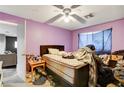 Bedroom with purple walls, unmade bed and poor housekeeping at 5900 Fawn Ave, Las Vegas, NV 89107