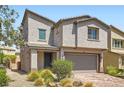 Inviting two-story home with manicured landscaping and a brick driveway at 5947 Wellington Peak Rd, Las Vegas, NV 89148