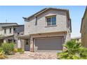 Inviting two-story home with attached two-car garage and beautiful landscaping at 5947 Wellington Peak Rd, Las Vegas, NV 89148