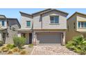Charming two-story home featuring desert landscaping and a two-car garage at 5947 Wellington Peak Rd, Las Vegas, NV 89148
