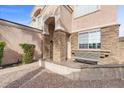 Charming entrance with stone accents, bench seating, and a decorative archway at 644 Wind Cave Ct, Henderson, NV 89012