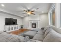 Inviting living room with a fireplace, hardwood floors, and comfortable gray seating at 644 Wind Cave Ct, Henderson, NV 89012