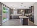 Modern kitchen has granite counters, dark cabinets and sliding doors to the backyard at 7345 Chesapeake Cove St, Las Vegas, NV 89166