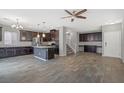 Open kitchen features dark cabinets, granite countertops and stainless steel appliances at 7345 Chesapeake Cove St, Las Vegas, NV 89166
