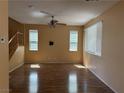 Inviting living room featuring wood floors and ample natural light from two windows at 8708 Gateway Glen Dr, Las Vegas, NV 89178