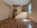 Open living space with wood floors and staircase access to the upper level at 8708 Gateway Glen Dr, Las Vegas, NV 89178