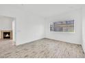 Comfortable bedroom with a window view, hardwood floors, and a cozy fireplace for added warmth at 8725 W Flamingo Rd # 110, Las Vegas, NV 89147