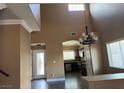Open concept living room features high ceilings and an open view to the kitchen at 9145 Sunken Meadow Ave, Las Vegas, NV 89178