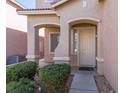 Charming front entrance featuring a covered porch, manicured bushes, and a welcoming front door at 9849 Ridge Hill Ave, Las Vegas, NV 89147